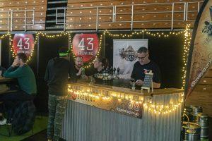 Craft beer festival at Taranaki with 43 Brewing, lively atmosphere, craft beer taps, and local brewers.