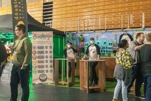 Handsome man in hoodie with beer at Taranaki Beer Festival, New Zealand.
