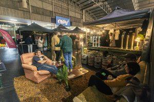Brewery tents at the Taranaki Beer Festival featuring craft beer stalls and attendees enjoying the event.