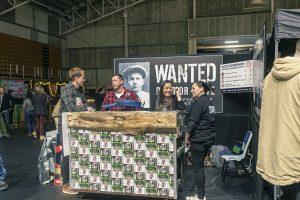 Sample image from the Taranaki Beer Festival showing festival attendees and staff at a beverage stall, highlighting local craft beer culture in New Zealand.