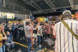 Vibrant crowd enjoying live music and craft beer at the Taranaki Beer Festival.