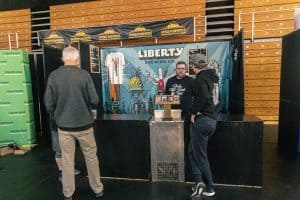 Vibrant Taranaki Beer Festival booth showcasing Liberty Brewing Co. craft beers and lively local beer culture.