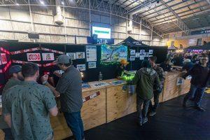 Craft beer tasting at Taranaki Beer Festival, lively indoor event with local brewers and attendees.