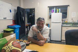 Smiling man at Taranaki Beer Festival enjoying local craft beers and vibrant festival atmosphere.