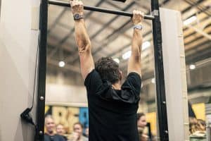 Vibrant man doing pull-ups at Taranaki Beer Festival in New Zealand.