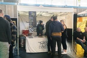 Ald text: Taranaki Beer Festival stall serving craft beers at the Taranaki Beer Festival in New Zealand.