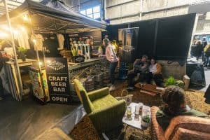 Craft beer bar at Taranaki Beer Festival with local brews and beer enthusiasts.