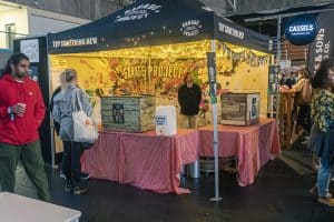 Vibrant Taranaki Beer Festival booth showcasing craft beers and lively atmosphere in New Zealand.