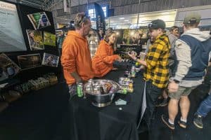 Craft beer tasting at Taranaki Beer Festival, showcasing local brews and lively crowd in an indoor event space.