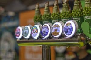 Bright illuminated beer taps featuring craft beer labels at Taranaki Beer Festival, showcasing a variety of local NZ brews.