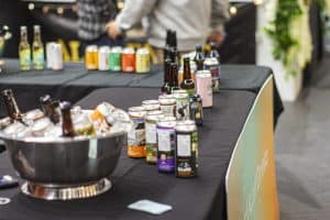 Assorted craft beers and cans on a black table at Taranaki Beer Festival, New Zealand.