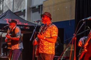 Vibrant live music performance at Taranaki Beer Festival, featuring local bands and craft beer enthusiasts in New Zealand.