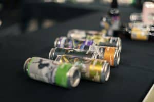 Cans of craft beer displayed at Taranaki Beer Festival, showcasing local and international brews.