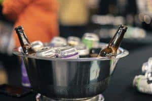 Cold beer bottles and cans in ice bucket at Taranaki Beer Festival, celebrating craft beers and local brewing.
