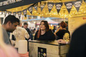Freshly brewed craft beers served at Taranaki Beer Festival with lively social atmosphere in New Zealand.