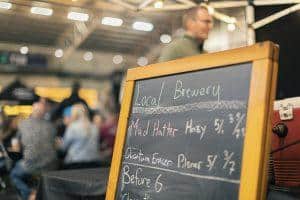 Hand-penned local craft beers at Taranaki Beer Festival, showcasing diverse brews like Mad Hatter Hazy and Quantum Ember Pilsner.