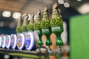 Colourful beer tap handles at Taranaki Beer Festival, showcasing craft beers and local brewing.
