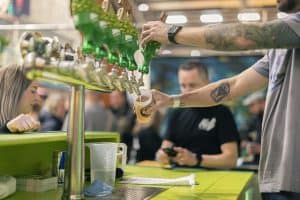 Refreshing craft beers being poured at Taranaki Beer Festival, showcasing local breweries and vibrant beer culture.