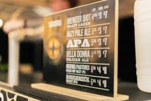 Bright beer menu board at Taranaki Beer Festival showcasing craft beers and ales, highlighting diverse flavour options.