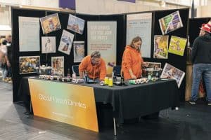 Colourful beer can display at Taranaki Beer Festival, highlighting craft beer vendors and tasting experience.