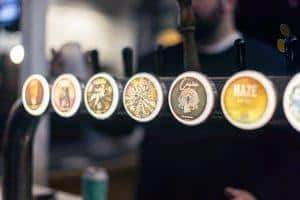 Assorted craft beer tap handles at Taranaki Beer Festival showcasing local NZ breweries.