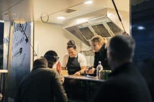 Craft beer stall at Taranaki Beer Festival with staff serving customers.