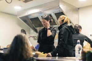 Convenient image of staff preparing food at Taranaki Beer Festival, showcasing local beer, food vendors, and lively event atmosphere in New Zealand.