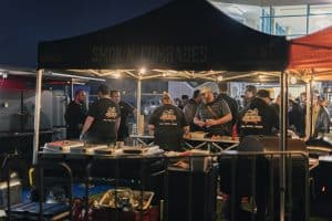 Vibrant scene at Taranaki Beer Festival with craft beer vendors and attendees enjoying a night of local brews.