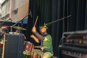 Vibrant drummer performing at the Taranaki Beer Festival in New Zealand with live music, highlighting craft beer and entertainment.