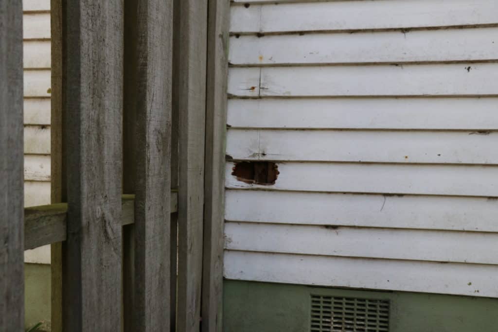view of a broken old door and a new one next to it after it has been fully repaired
