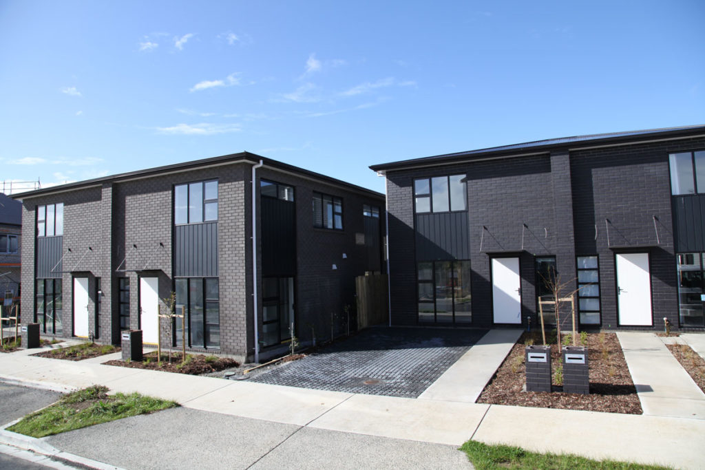 Modern timber-framed townhouses at Te Tumu Kāinga development, New Zealand.
