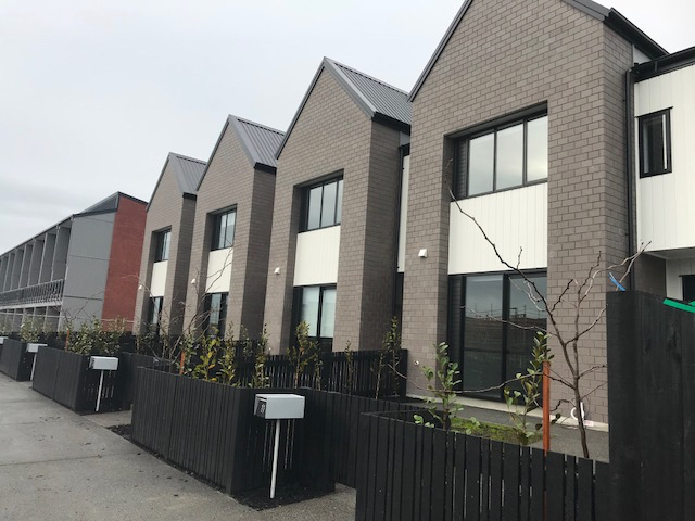 Modern suburban housing development with contemporary townhouses in Auckland, New Zealand.