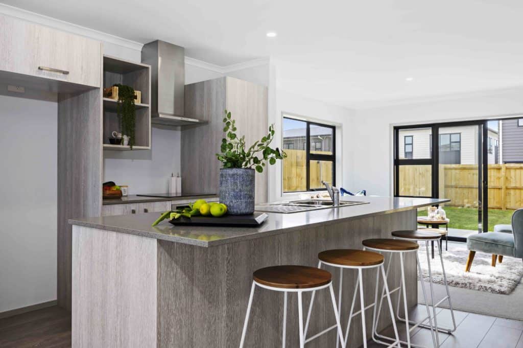 Modern kitchen with island, home for Te Tumu Kāinga community housing in New Zealand.