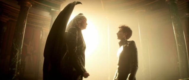 Angel and man facing each other in a dramatic, backlit scene from The Sandman series.