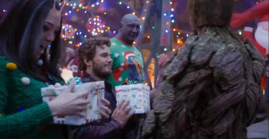 A Christmas scene with Guardians of the Galaxy characters exchanging gifts at a festive holiday part.