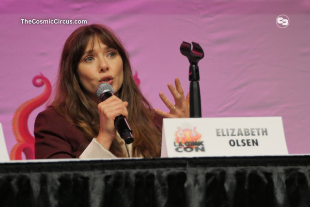Elizabeth Olsen on stage with a red background