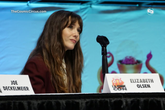 Elizabeth Olsen on stage with a blue background