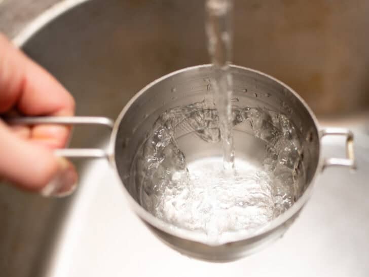 Pour water into measuring cup