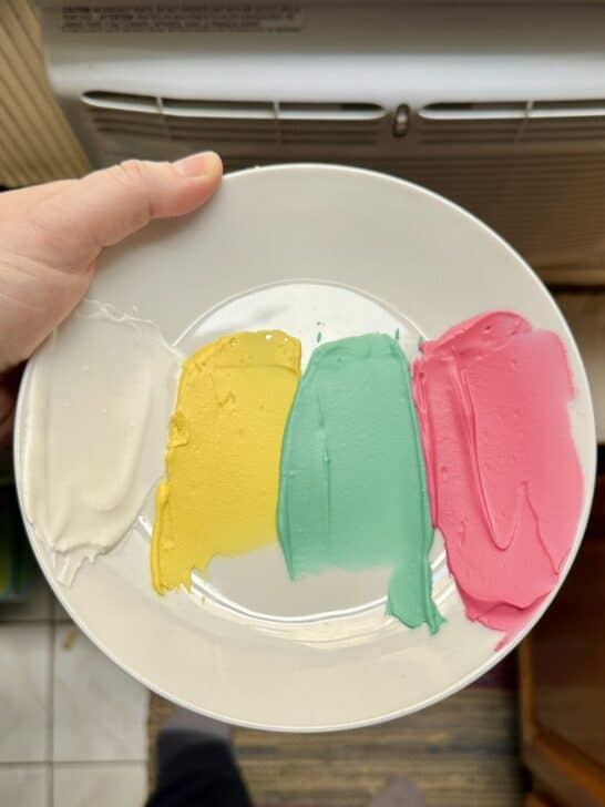 picture of royal icing swatches on a white plate 