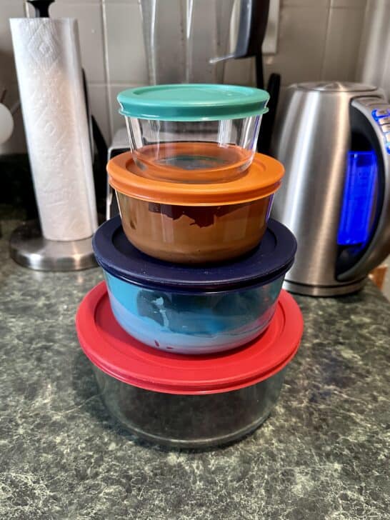 photo of four different sizes of glass pyrex bowls with plastic lids for storing royal icing