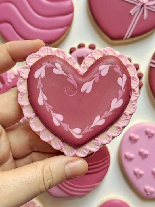 heart cookie decorated with royal icing to demonstrate how much icing is needed for details