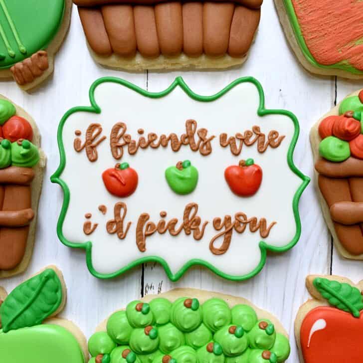 photo of cookie decorated with royal icing using magnolia sky font saying IF FRIENDS WERE APPLES I'D PICK YOU 