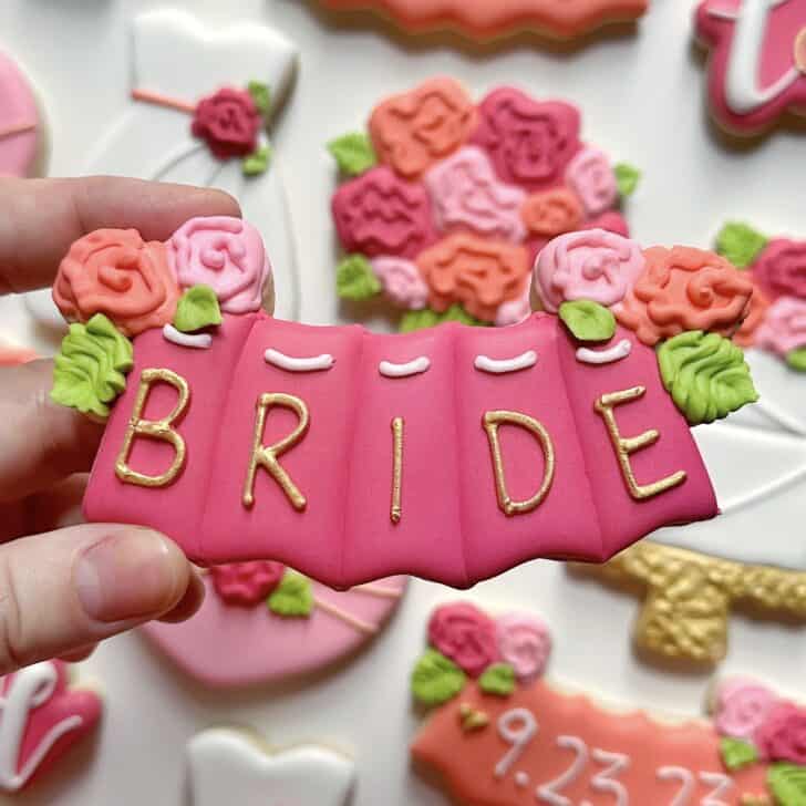photo of writing with royal icing on a cookie: simple line saying BRIDE