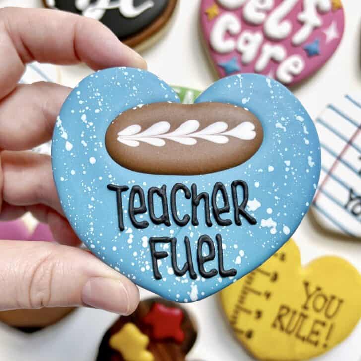 photo of freehanded writing with royal icing saying TEACHER FUEL