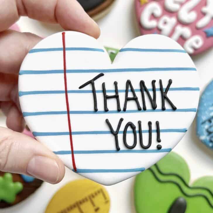 photo of writing with royal icing on a cookie: simple line saying THANK YOU