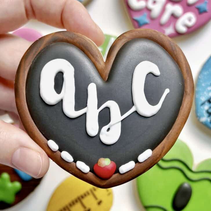 photo of writing with royal icing on a cookie: pressure piped saying ABC