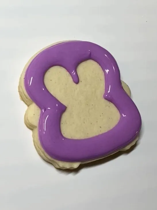 decorating penguin cookies with royal icing