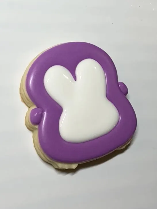 decorating penguin cookies with royal icing