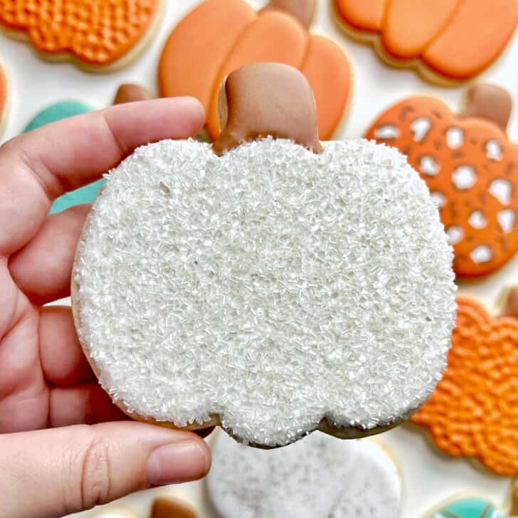 white sparkle Pumpkin Cookies with royal icing