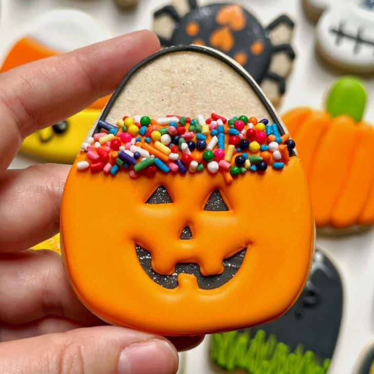 photo of jack o' lantern halloween cookie decorated with royal icing
